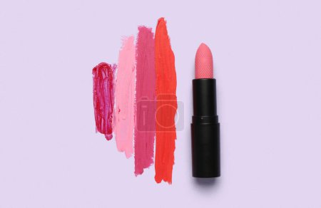 Photo for Beautiful lipstick with different strokes on purple background - Royalty Free Image