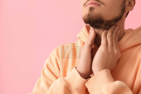 Photo for Young man with thyroid gland problem on pink background, closeup - Royalty Free Image