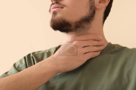Photo for Young man with thyroid gland problem at home, closeup - Royalty Free Image