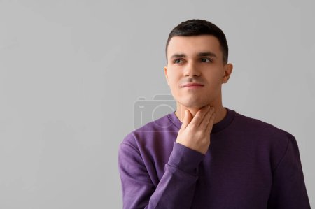 Photo for Young man with thyroid gland problem on light background - Royalty Free Image