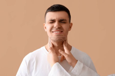 Photo for Endocrinologist examining thyroid gland of young man on beige background, closeup - Royalty Free Image