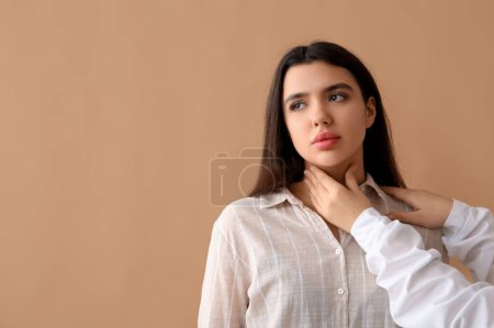 Photo for Endocrinologist examining thyroid gland of young woman on beige background - Royalty Free Image