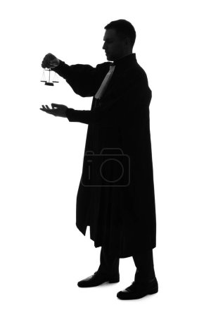 Silhouette of male judge with justice scales on white background