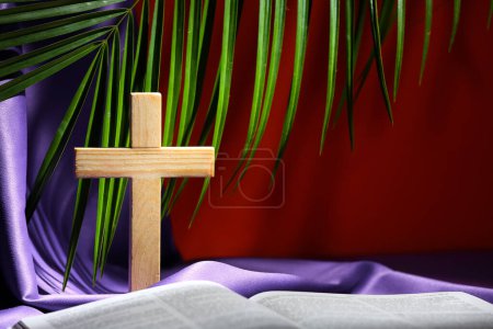 Photo for Wooden cross with purple cloth, palm leaf and Bible on red background. Good Friday concept - Royalty Free Image