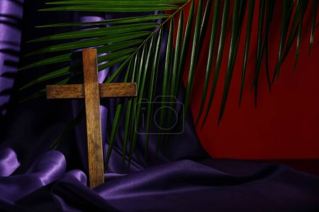 Photo for Wooden cross with purple cloth and palm leaf on red background. Good Friday concept - Royalty Free Image