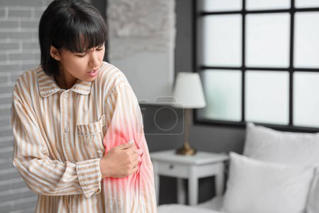 Photo for Young woman feeling pain in elbow at home - Royalty Free Image