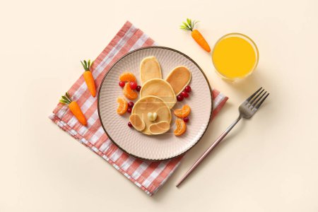 Téléchargez les photos : Crêpes de lapin de Pâques drôle avec verre de jus d'orange sur fond blanc - en image libre de droit