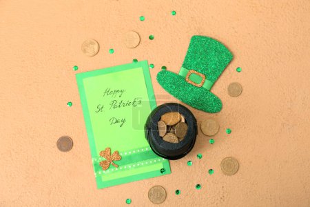 Photo for Leprechaun pot with golden coins, paper hat and card on beige background. St. Patrick's Day celebration - Royalty Free Image
