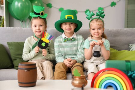 Photo for Cute kids celebrating St. Patrick's Day with festive green outfits at home party - Royalty Free Image