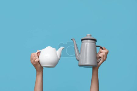 Woman with teapots on blue background