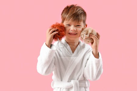 Photo for Cute little boy in bathrobe with loofahs on pink background - Royalty Free Image