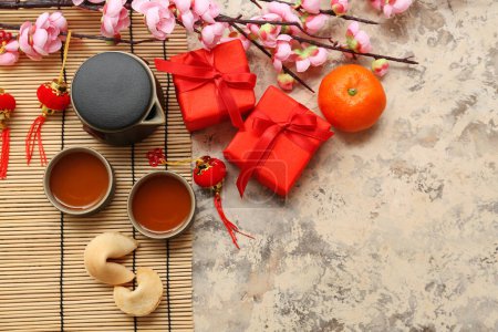 Photo for Gift boxes with cups of tea, fortune cookies and mandarin on grunge background. New Year celebration - Royalty Free Image