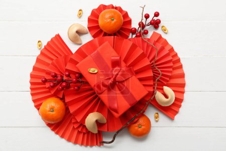 Photo for Gift box with fortune cookies, mandarins and Chinese symbols on white wooden background. New Year celebration - Royalty Free Image
