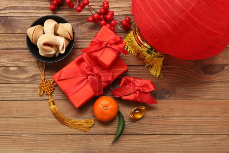 Photo for Gift boxes with fortune cookies, mandarin and lantern on wooden background. New Year celebration - Royalty Free Image