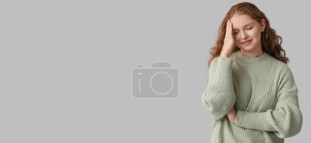 Photo for Young woman feeling awkward on grey background with space for text - Royalty Free Image
