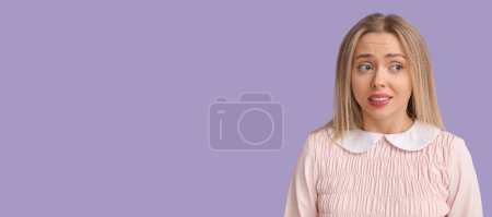 Photo for Embarrassed young woman on lilac background with space for text - Royalty Free Image