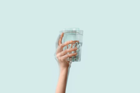 Photo for Trembling hand with glass of water on light background. Parkinson's Awareness Month - Royalty Free Image