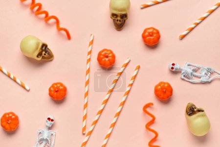 Composition with paper drinking straws and Halloween decorations on color background