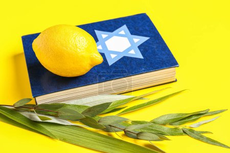 Four species (lulav, hadas, arava, etrog) as Sukkot festival symbols and Torah on yellow background