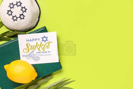 Four species (lulav, hadas, arava, etrog), Torah and greeting card with text HAPPY SUKKOT on green background
