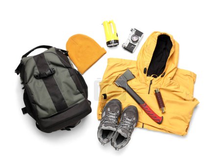 Photo for Set of hiking essentials with backpack, raincoat and outdoor gear on white background - Royalty Free Image