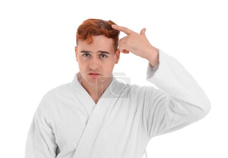 Sad redhead man with problem of dandruff on white background