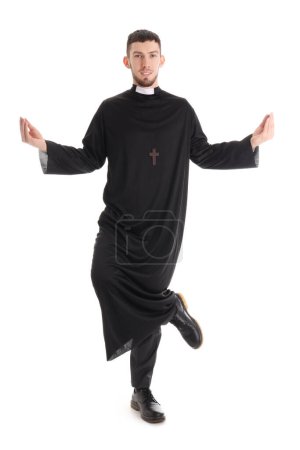 Young priest meditating on white background