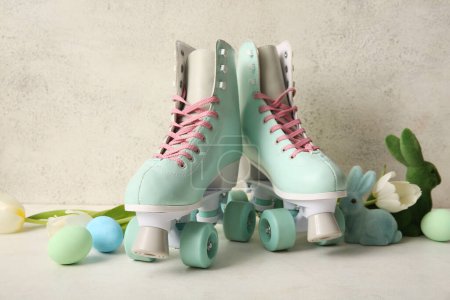Vintage roller skates with Easter eggs, beautiful tulips and toys bunny on white background