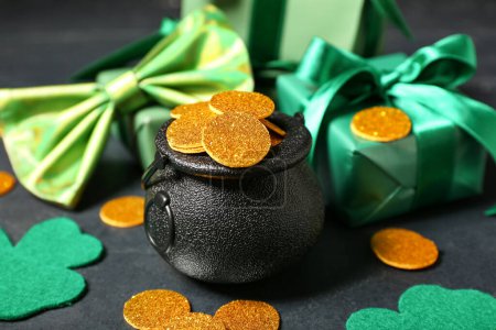 Photo for Leprechaun pot with golden coins and gift boxes on table against dark background. St. Patrick's Day celebration - Royalty Free Image