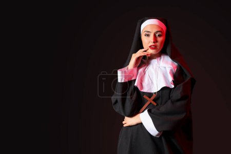 Naughty nun on dark background