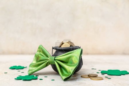 Photo for Leprechaun pot with golden coins and clover leaves on beige grunge background. St. Patrick's Day celebration - Royalty Free Image