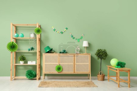 Photo for Interior of festive living room with wooden cabinet and decorations for St. Patrick's Day celebration - Royalty Free Image