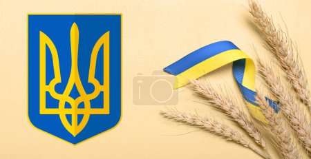 Wheat spikelets and ribbons in colors of Ukrainian flag with coat of arms on yellow background