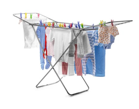 Dryer with clean baby clothes against white background