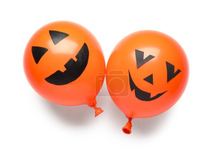 Different orange Halloween balloons on white background