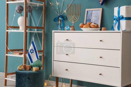 Photo for Chest of drawers and ottoman with traditional Hanukkah decorations in living room, closeup - Royalty Free Image