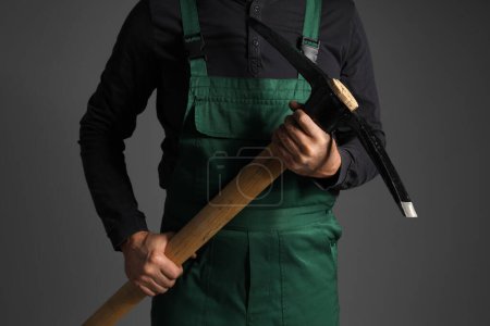 Photo for Mature miner man with pick axe on dark background - Royalty Free Image