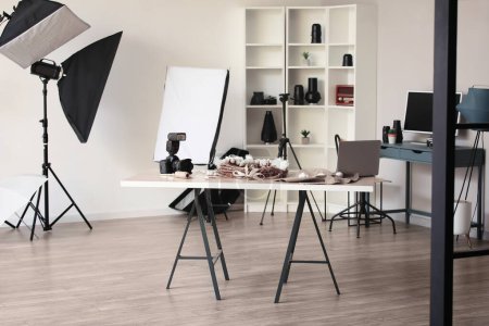 Interior of photo studio with tables and professional equipment