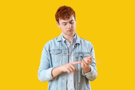 Photo for Young redhead man counting on yellow background - Royalty Free Image