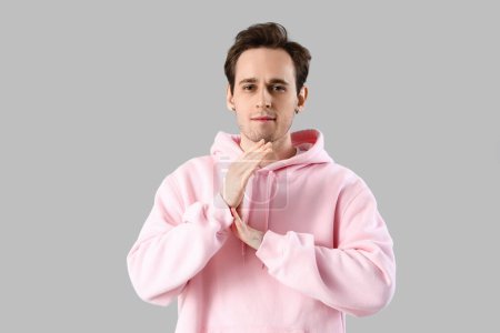 Photo for Young man gesturing on light background - Royalty Free Image