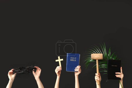 Photo for Female hands with Holy Bibles, crown of thorns, mallet and palm leaf on dark background. Good Friday concept - Royalty Free Image