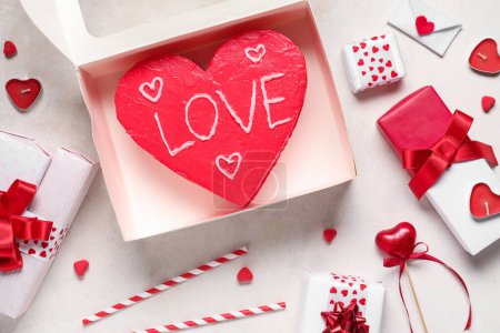 Photo for Heart-shaped bento cake with gift boxes on white background. Valentine's Day celebration - Royalty Free Image
