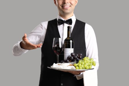 Photo for Young sommelier with wine and snacks on grey background, closeup - Royalty Free Image