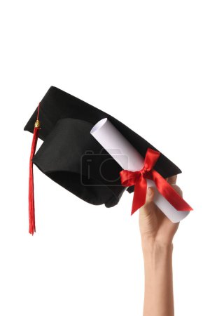 Photo for Female hand with graduation hat and diploma on white background - Royalty Free Image