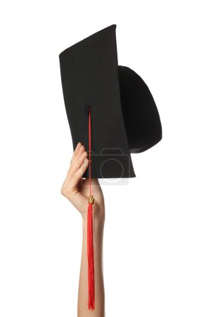 Photo for Female hand with graduation hat on white background - Royalty Free Image
