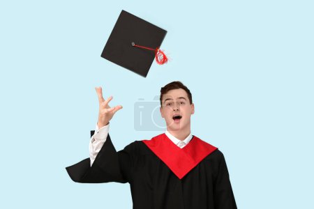 Photo for Male graduating student with mortar board on blue background - Royalty Free Image