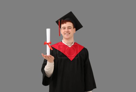 Photo for Male graduating student with diploma on grey background - Royalty Free Image