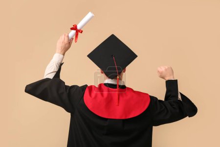 Photo for Male graduating student with diploma on beige background - Royalty Free Image