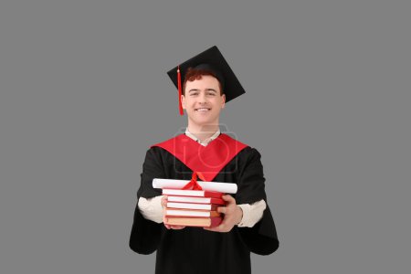 Photo for Male graduating student with diploma and books on grey background - Royalty Free Image