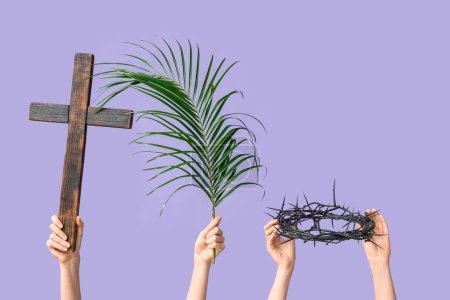 Photo for Female hands with wooden cross, palm leaf and crown of thorns on lilac background. Good Friday concept - Royalty Free Image